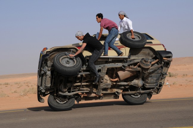 Saudi youths demonstrate a stunt known as sidewall skiing (driving on two wheels) in the northern city of Hail, in Saudi Arabia March 30, 2013. Performing stunts such as sidewall skiing